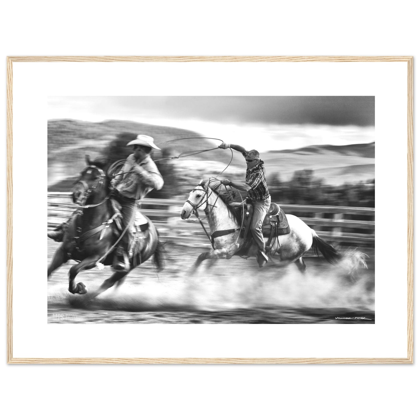 Black & white  print of two cowboys wrangling in close contact in a corall.
