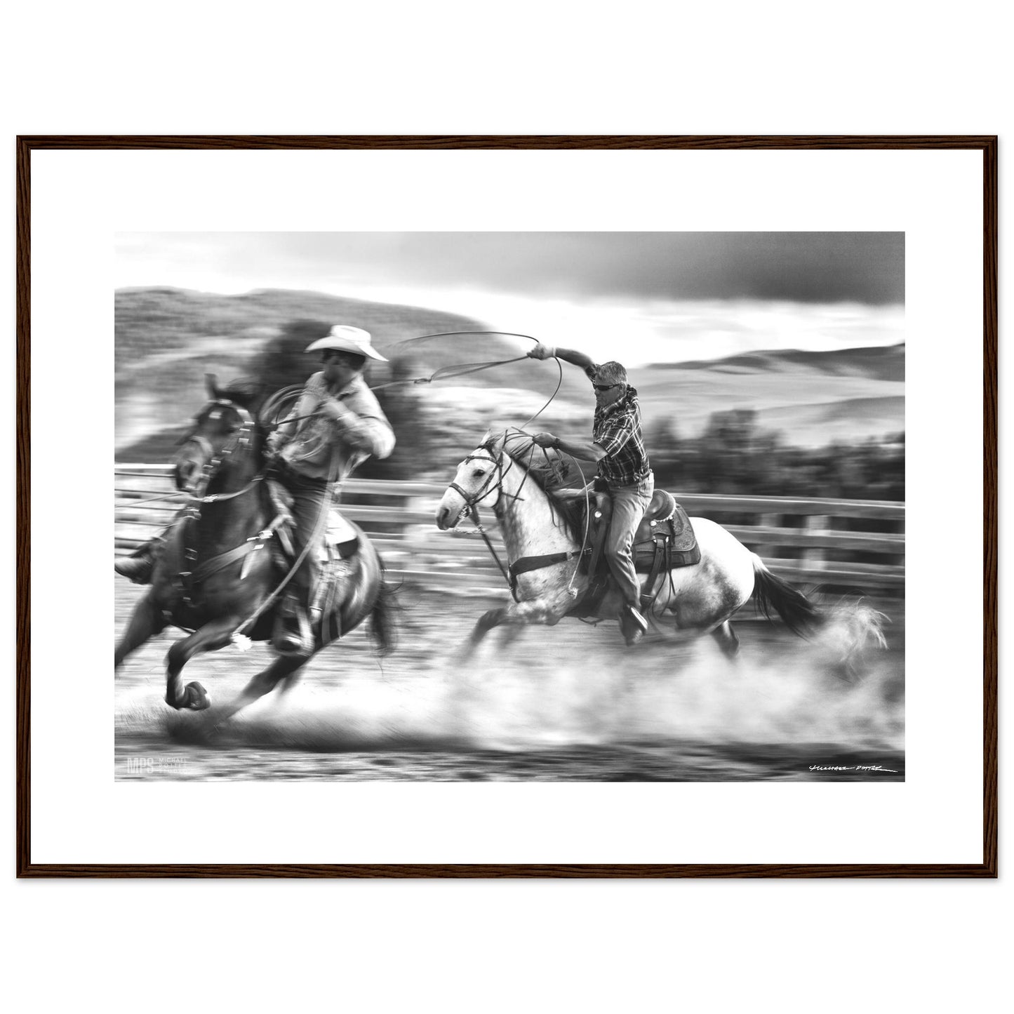 Black & white  print of two cowboys wrangling in close contact in a corall.